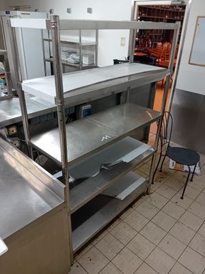 a kitchen with stainless steel shelves and a metal counter