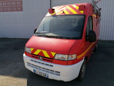 an image of a red and yellow fire truck parked in front of a building