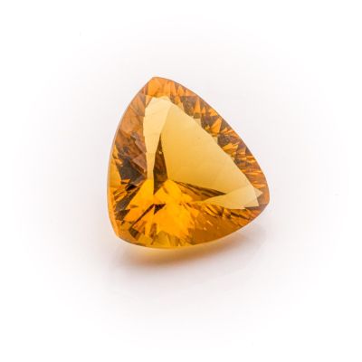 a close up of a yellow diamond on a white surface