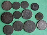 several different types of coins are arranged on a green surface