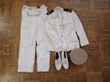 a picture of a white suit and hat on a wooden floor