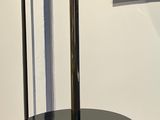 a table with a lamp and a mirror on the wall
