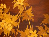a close up of a painting of flowers on a table