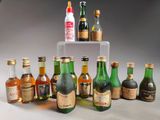 several bottles of alcohol are lined up on a clear shelf