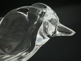a glass bird that is sitting on top of a table