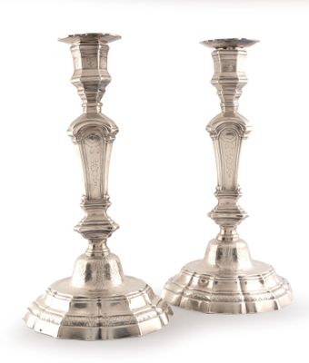 pair of silver candlesticks on a white background with a white background