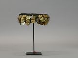 a close up of a lamp on a metal stand with coins on it