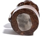 a small wooden object with writing on it on a white surface