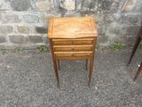 a small wooden table with a drawer on top of it