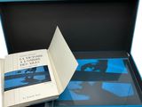 a blue box with a book in it on a white background