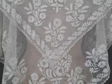 a close up of a white wedding veil on a mannequin