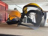 a pair of safety glasses and a helmet sitting on a shelf