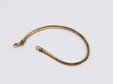 a gold bracelet with a snake on it