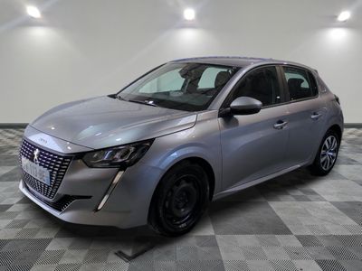 a silver car parked on a checkered floor in a garage