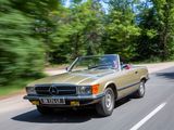 a car that is driving down the road in the daytime