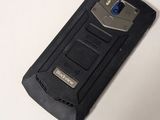 a cell phone that is sitting on a table next to a mouse