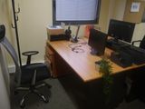 a desk with two computers and a monitor on it