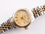 an image of a lady ' s rolex watch with two tone bracelets