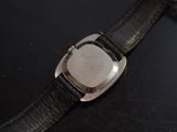 a close up of a watch on a black surface