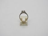 a white gold ring with a diamond on top of it