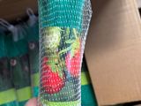 a person holding a bag of strawberries in front of a box