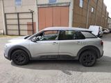 a silver car parked on the side of the road