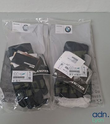 two pairs of gloves that are wrapped in plastic