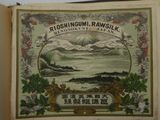 an old book with a picture of a mountain in the background
