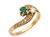 a close up of a gold ring with a green and white stone