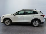 the white volvo suv is parked in a room with a gray floor