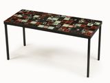 the table is made of black and red tiles with black legs