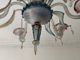 a chandelier hanging from the ceiling in a room