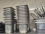 many pots and pans sitting on the kitchen counter