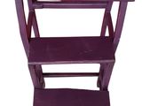a small wooden step stool with two shelves on it