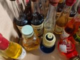 many bottles of alcohol sitting on a table