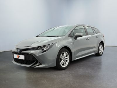 a grey toyota corollion parked in a white room