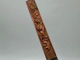 an image of a wooden stick with a carved design on it