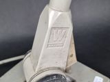 a close up of a metal object with a button on it