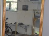 a large mirror in a room with a bike in the background