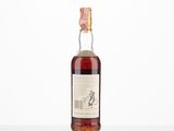a bottle of whisky sitting on top of a white table