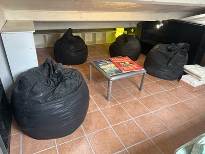 black bean bags sitting on the floor in a room