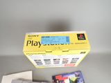 a box of video games and a game controller on a table