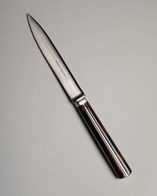 a knife that is laying on a table