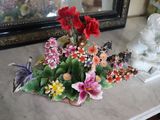a vase with flowers on a table next to a mirror
