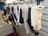 a lot of clothes hanging on a rack in a store