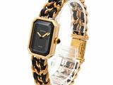 an image of a black and gold watch with a chain bracelet