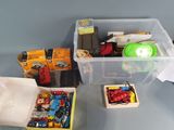 a plastic container filled with assorted toys on a table