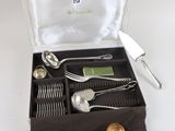 a box with silverware in it on a white surface