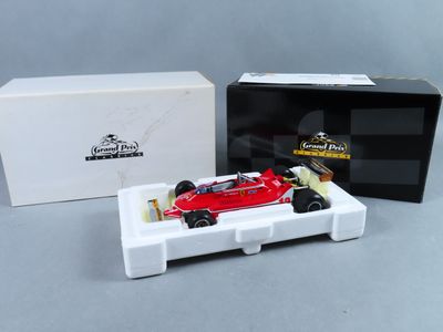 l'image d'une voiture de course rouge dans une boîte, à côté d'une boîte blanche