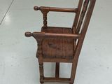 a wooden chair that is sitting on the floor in a room